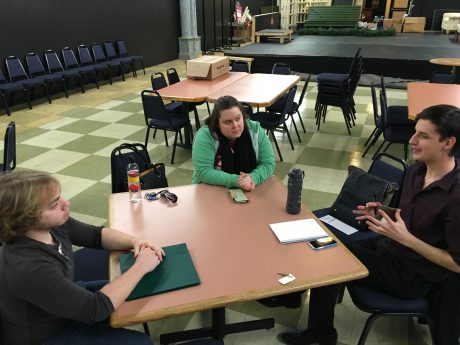 Cast and director sitting at table of first cast meeting.